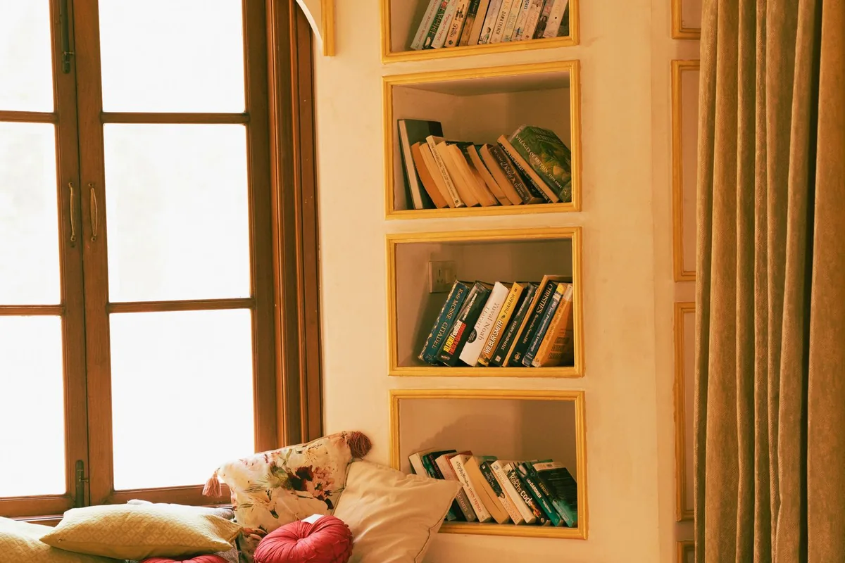 Built-in cabinetry and shelving framing a living room wall in a Newport Beach CA home
