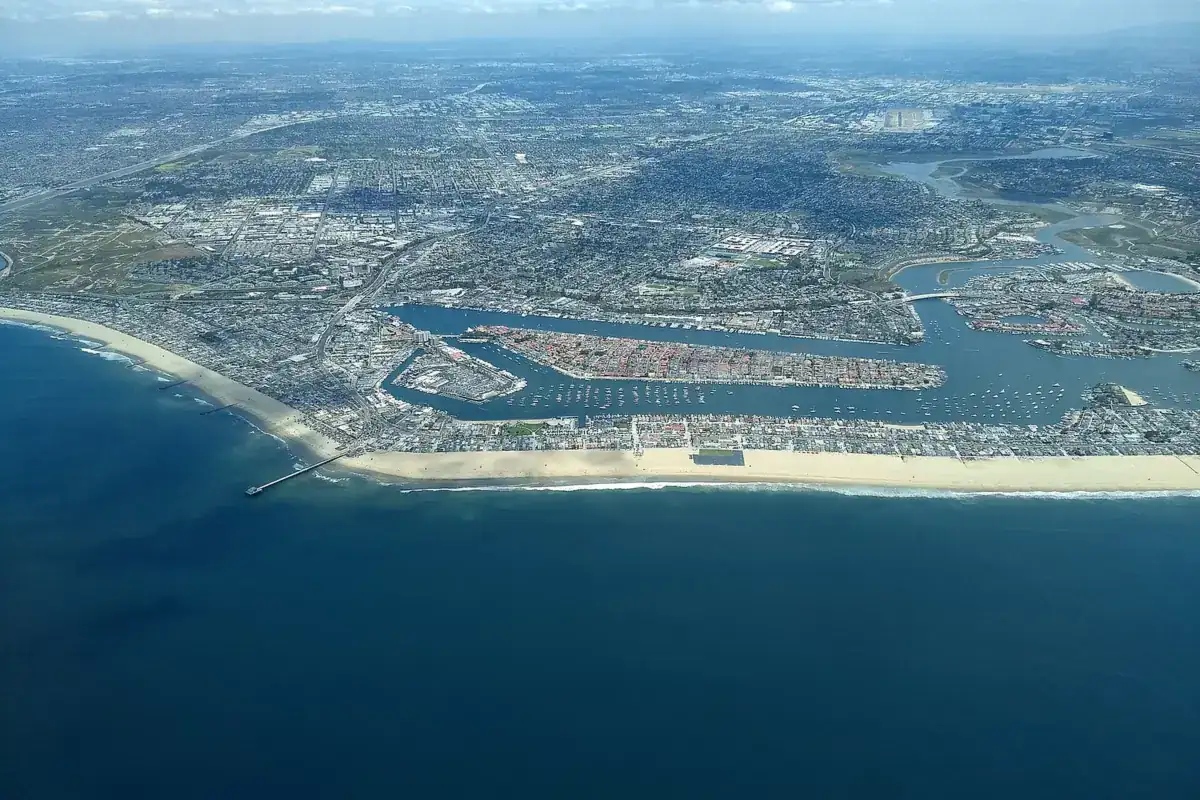 Aerial view north across Newport Bay toward the bluff neighbourhoods above the harbour, Newport Beach CA