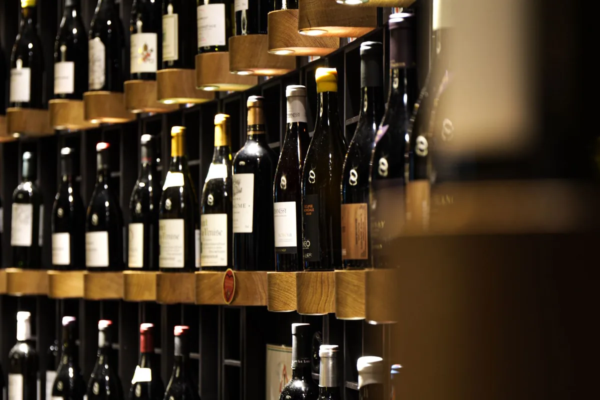 Wine bottles stored horizontally in timber peg racking in a Newport Beach CA home