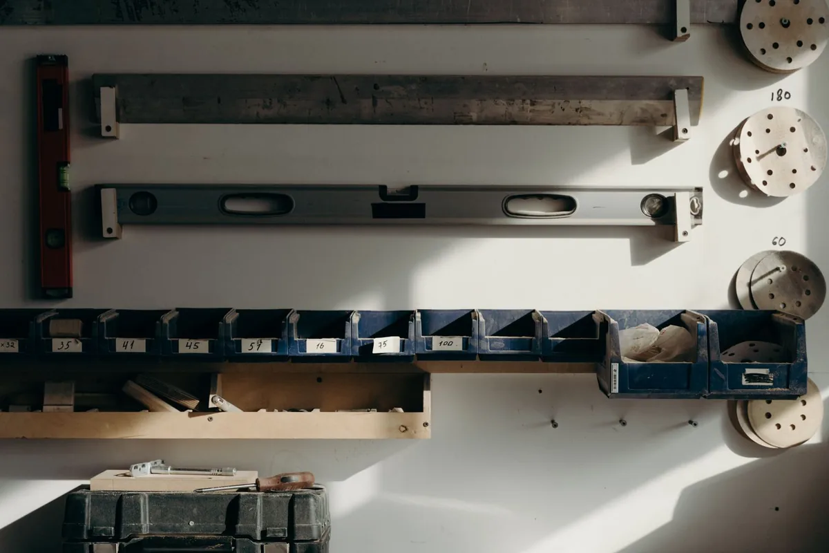 A workshop wall with levels, straightedges and parts bins used for checking cabinet work near Newport Beach CA